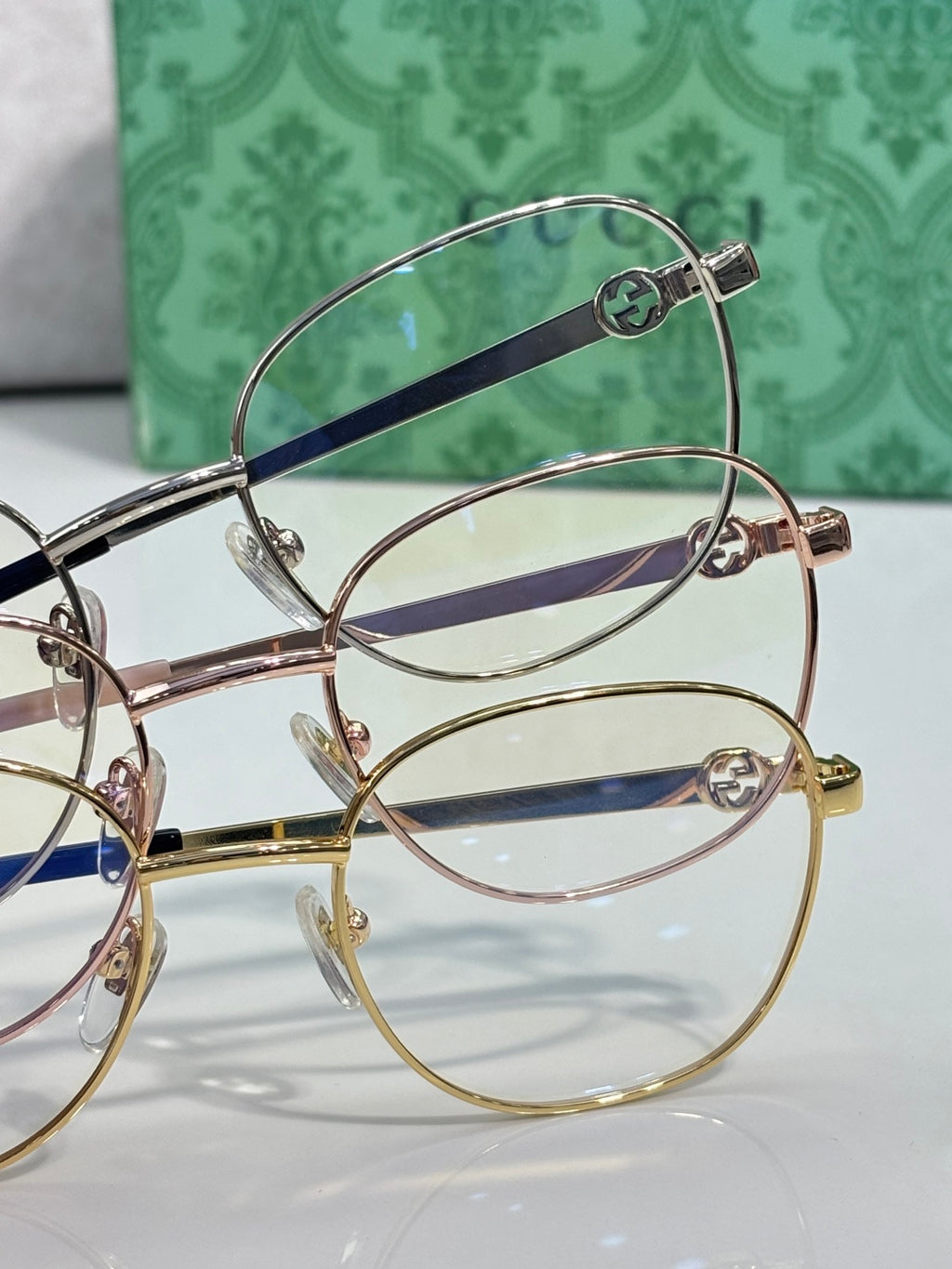 Round metal eyeglasses frames in mixed finishes with clear lenses and dark blue temples