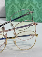 Round metal eyeglasses frames in mixed finishes with clear lenses and dark blue temples