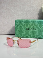 Sunglasses with gold frame and pink-tinted lenses, with Gucci logo arm