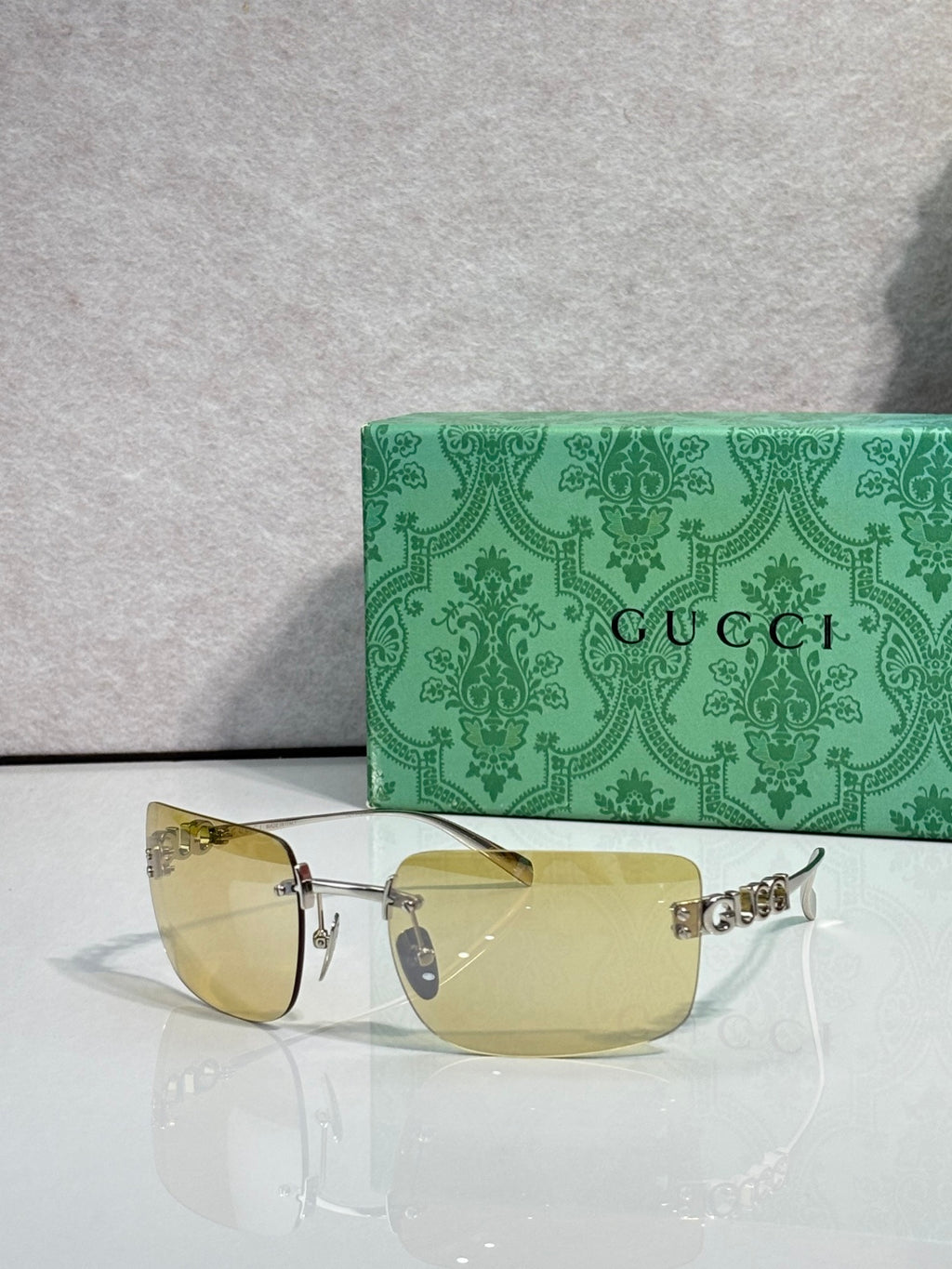 Sunglasses with gold frame and light yellow-tinted lenses