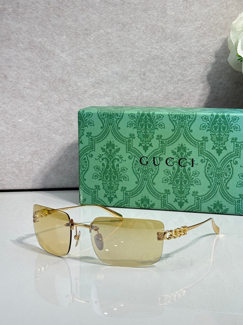 Gucci sunglasses with gold frame and clear yellow-tinted lenses