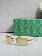 Gucci sunglasses with gold frame and clear yellow-tinted lenses