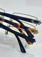 Cartier glasses close-up of dark blue and tortoiseshell temples, clear lenses