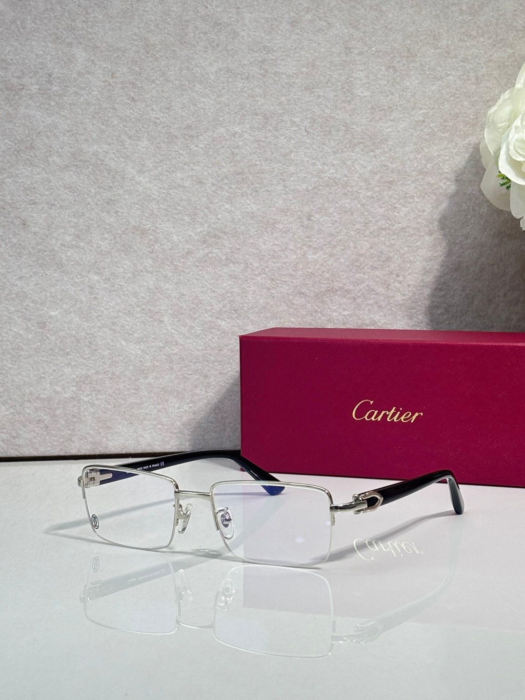 Cartier glasses with black frame and clear rectangular lenses, gold hinge details