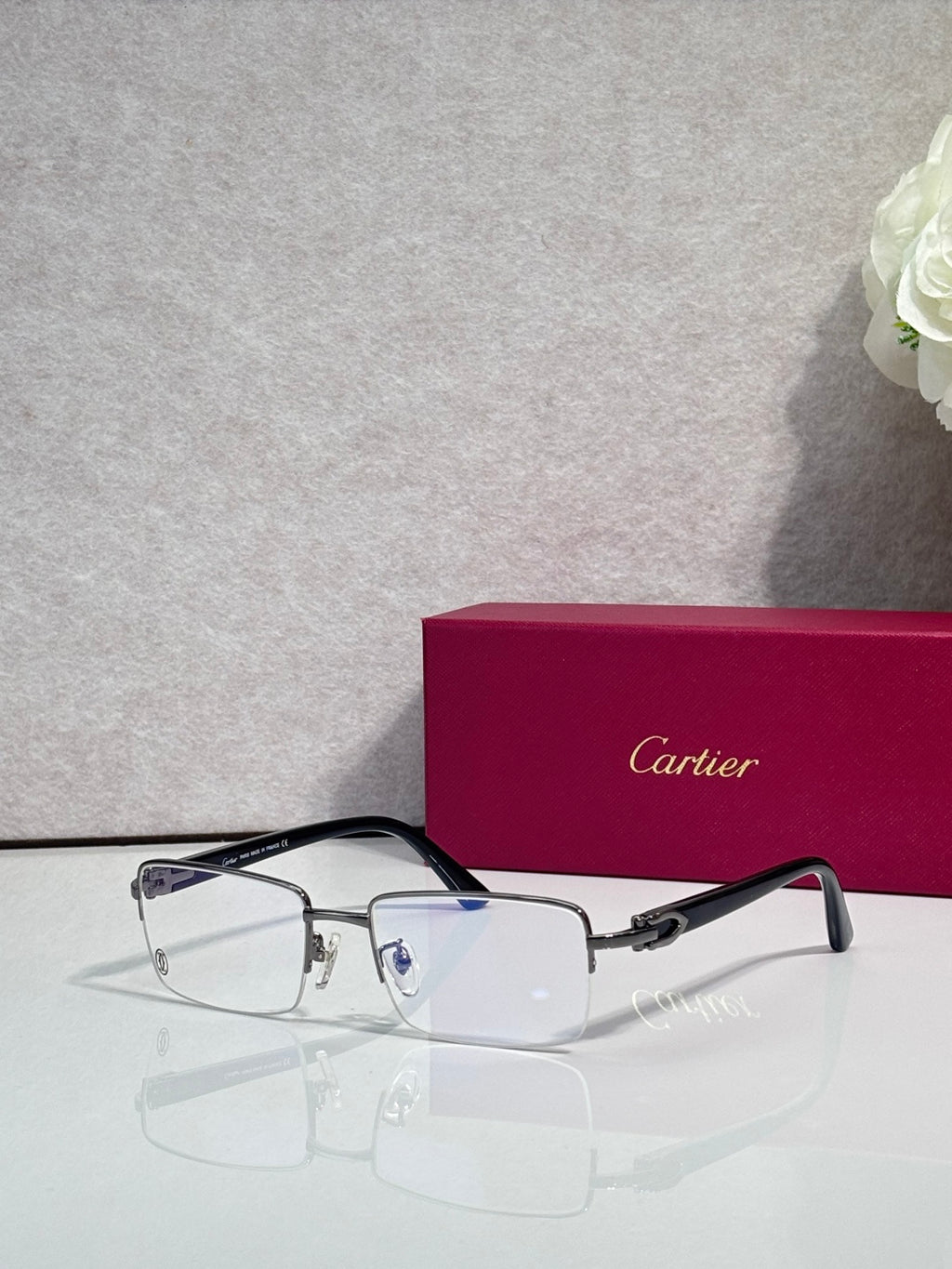 Cartier glasses with black frame and clear rectangular lenses, slim metal temples