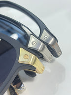 Dark blue eyeglass temples with gold and silver hinge details