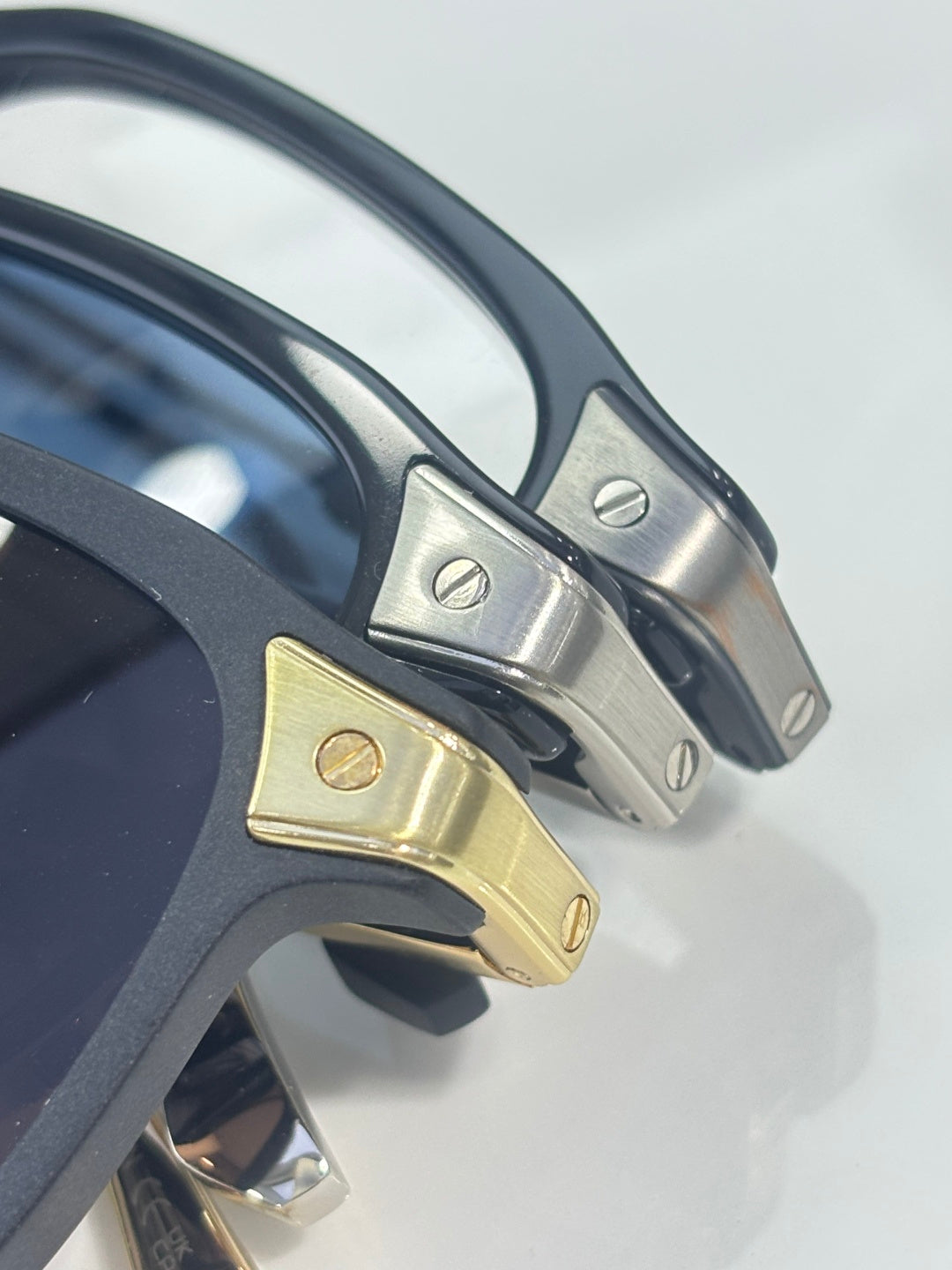 Dark blue eyeglass temples with gold and silver hinge details