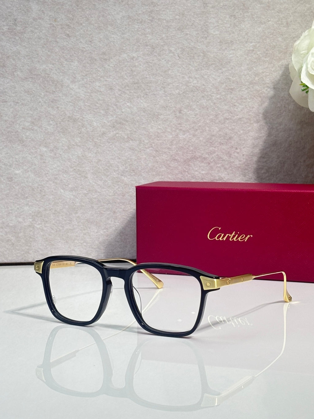 Blue rectangular eyeglasses with clear lenses and gold temple details