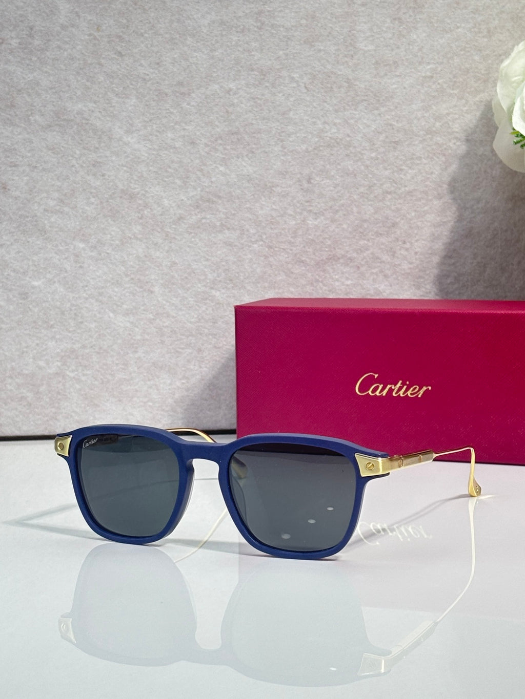 Navy blue square eyeglasses with tinted lenses and gold metal accents