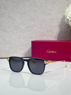 Blue eyeglasses with dark lenses, square frames, and gold-tone metal temple details.