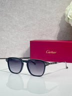 Navy eyeglasses with dark lenses, square frames, and gold-tone hinge accents.