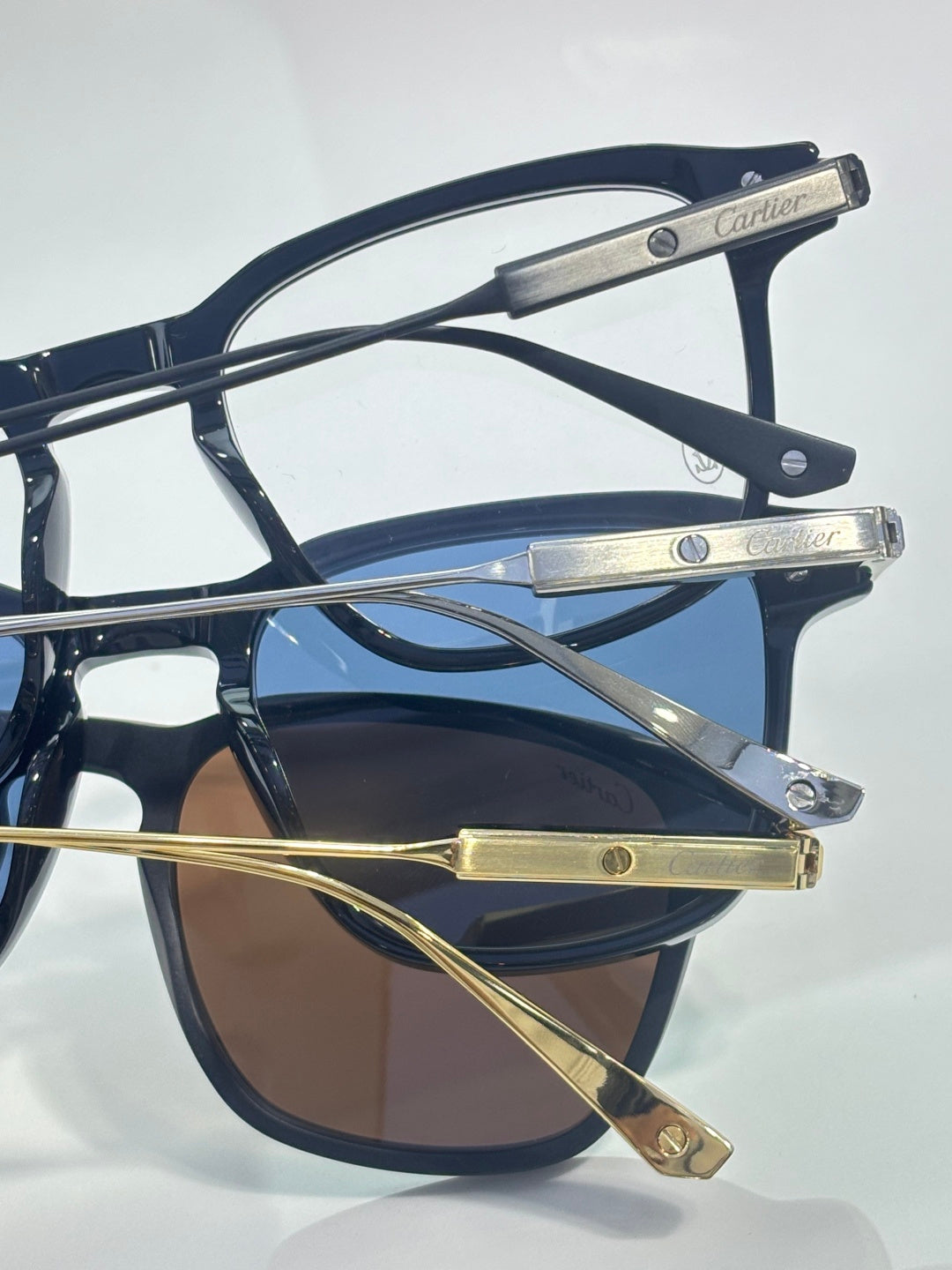 Angled view of navy and gold eyeglasses with metal bridge and gold-tone temple tips.
