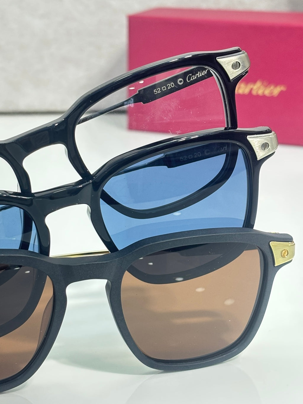 Side view of navy eyeglasses with gold-tone hinges and stacked frame temples.