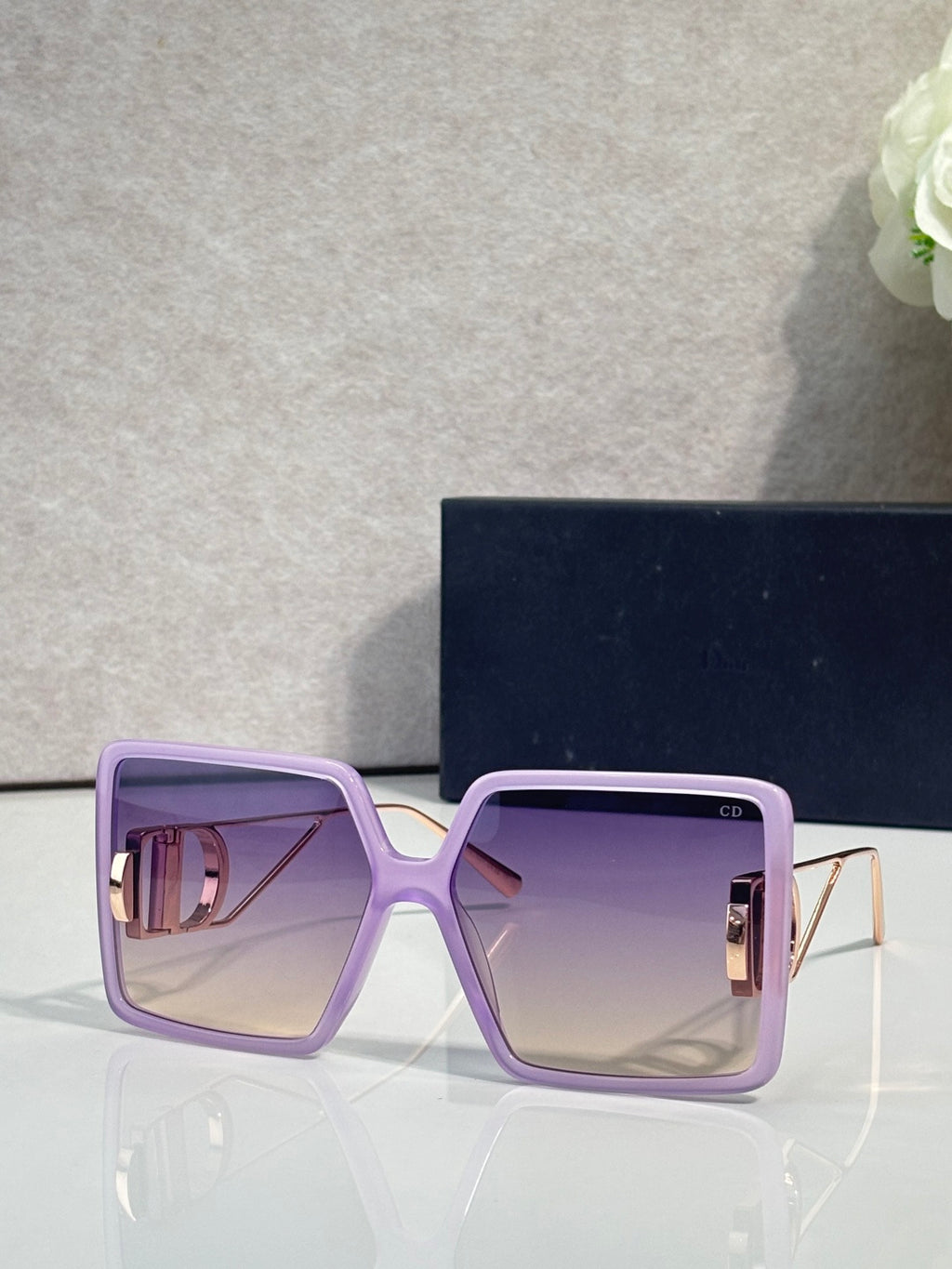 Sunglasses with lavender square frames and purple tinted lenses