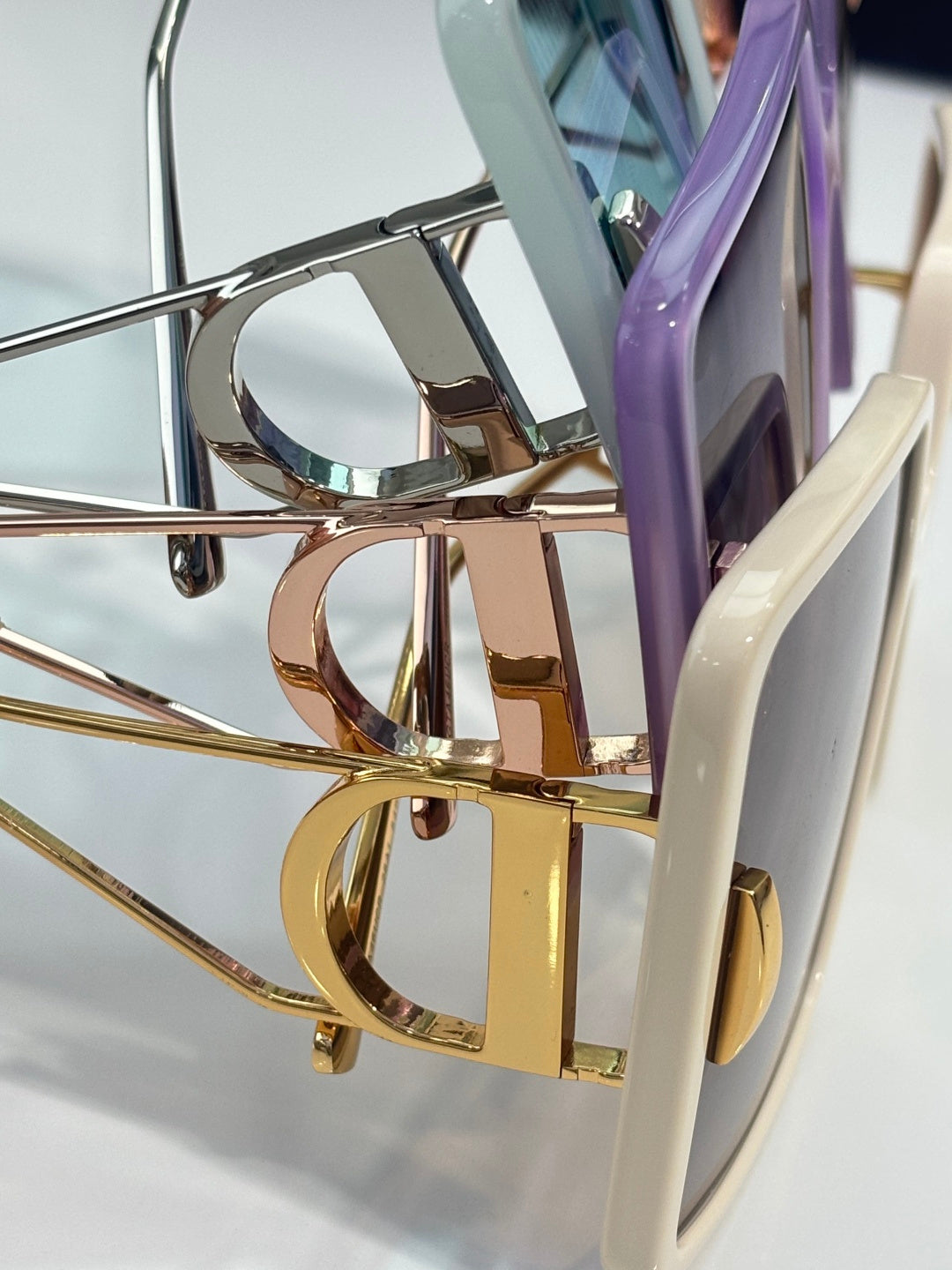 Square sunglasses closeup with reflective metal hinge and temple hardware