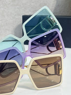Pastel square sunglasses stack with light blue, lavender, and beige frames