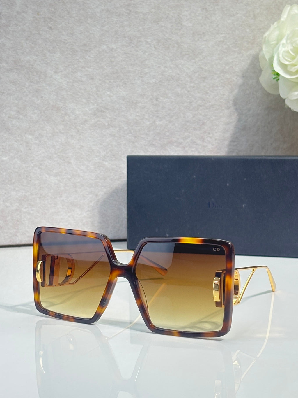 Tortoiseshell square sunglasses with amber gradient lenses and gold-tone accents