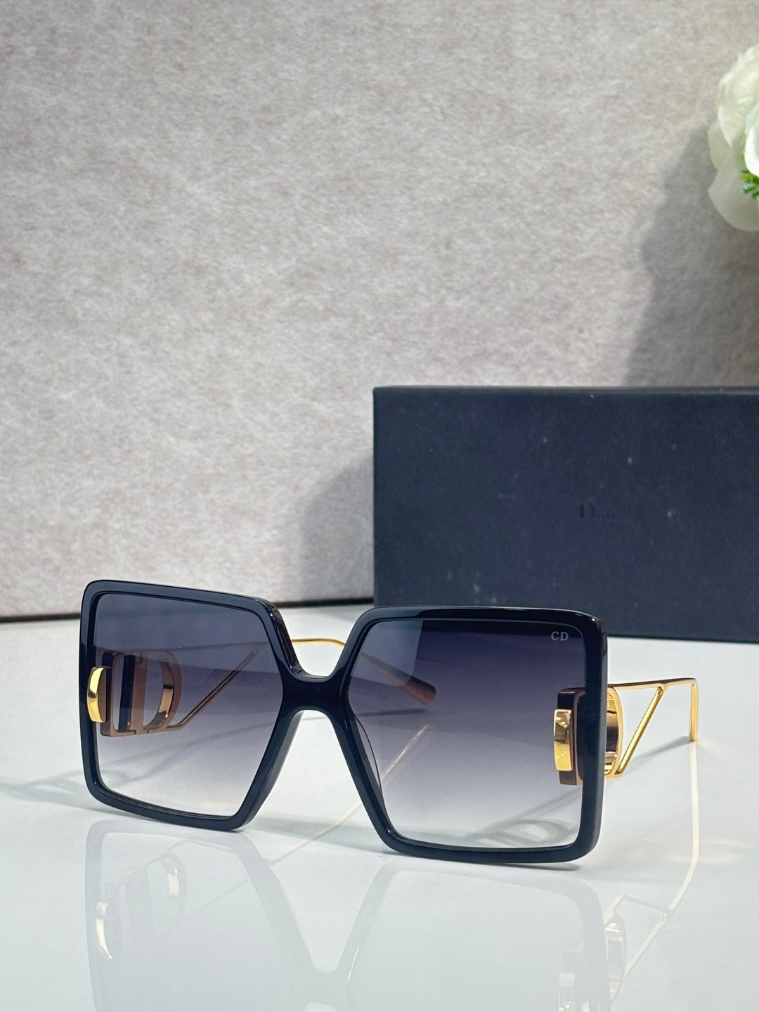 Navy square sunglasses with gradient lenses and gold-tone metal details