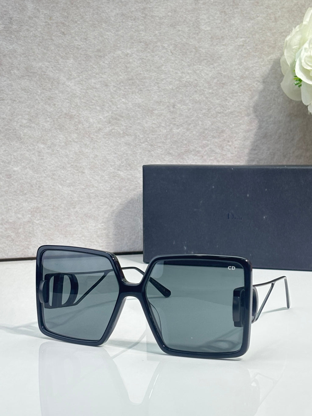 Dark blue square sunglasses with blue-tinted gradient lenses and gold-tone accents