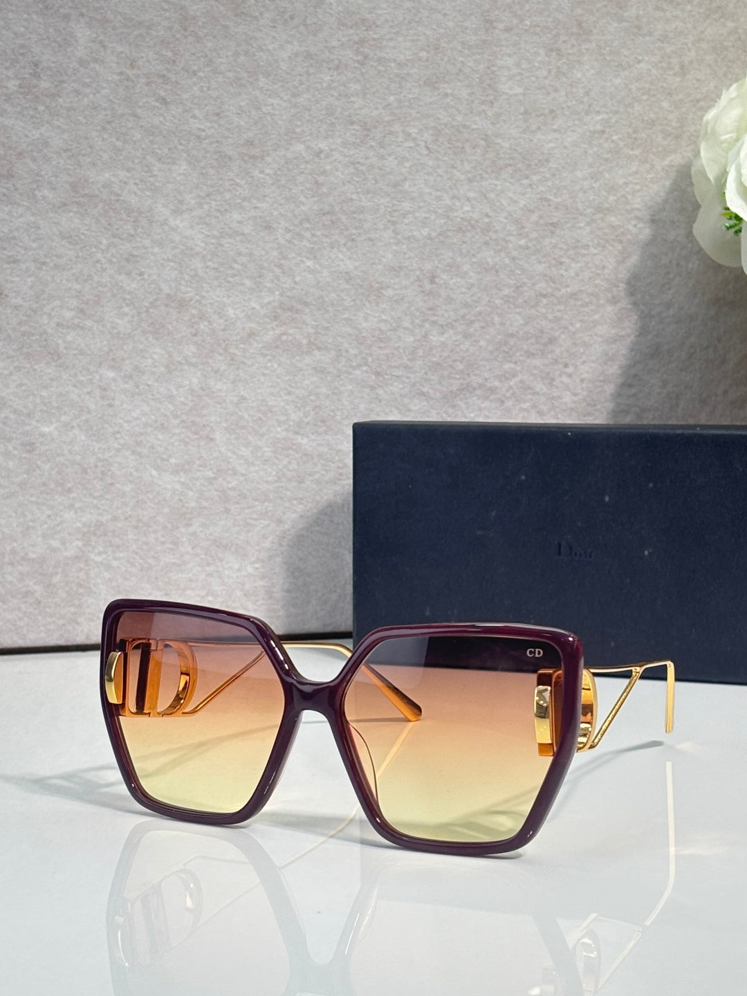 Dior sunglasses with burgundy frames and golden square tinted lenses