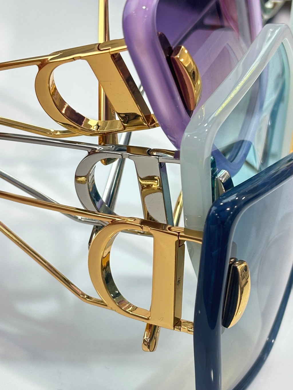 Dior sunglasses gold-tone hinge and temple detail with tinted lens edge