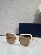 Dior sunglasses with cream frames, gold accents, and brown square tinted lenses