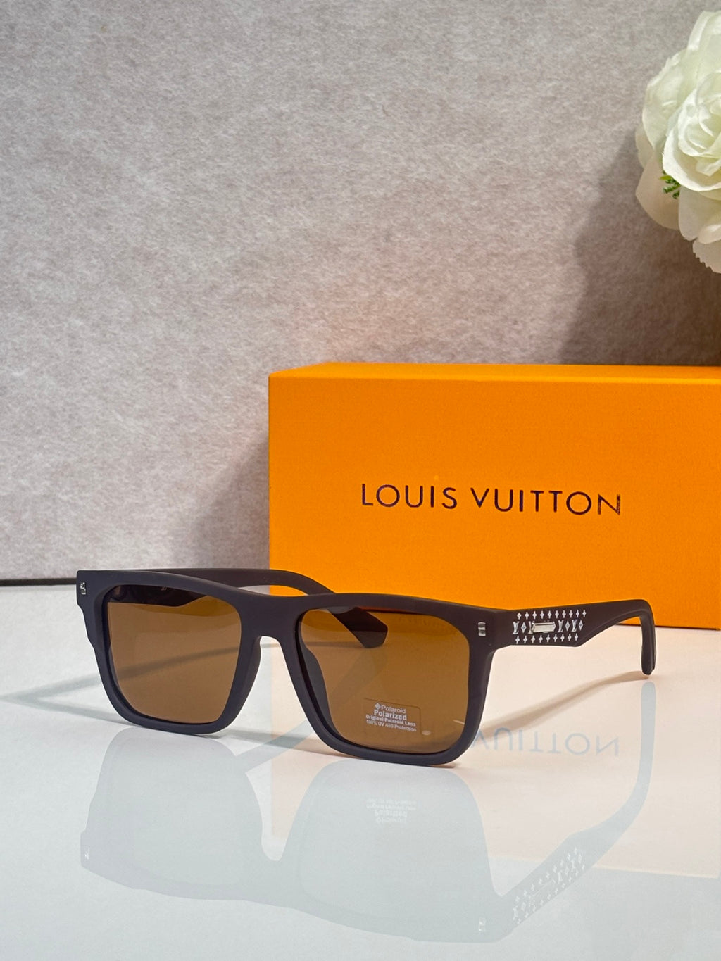 Louis Vuitton square sunglasses with navy frames and amber-tinted lenses