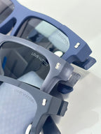Louis Vuitton sunglasses close-up with navy frame and metal logo detail