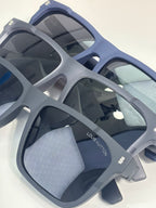 Louis Vuitton sunglasses close-up with light gray square frames and dark lenses