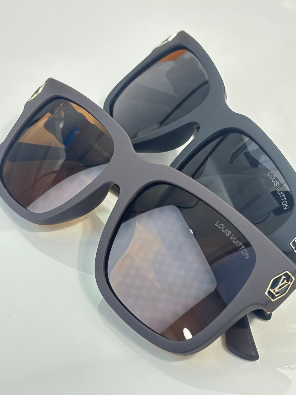 Louis Vuitton sunglasses with dark gray frames and tinted lenses, pair angled view
