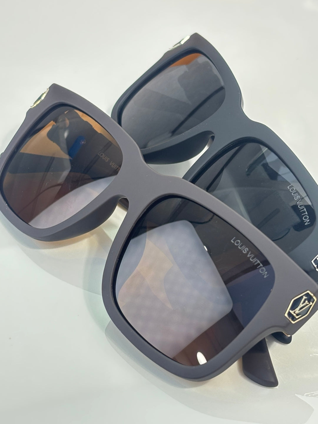 Louis Vuitton sunglasses with dark gray frames and tinted lenses, pair angled view