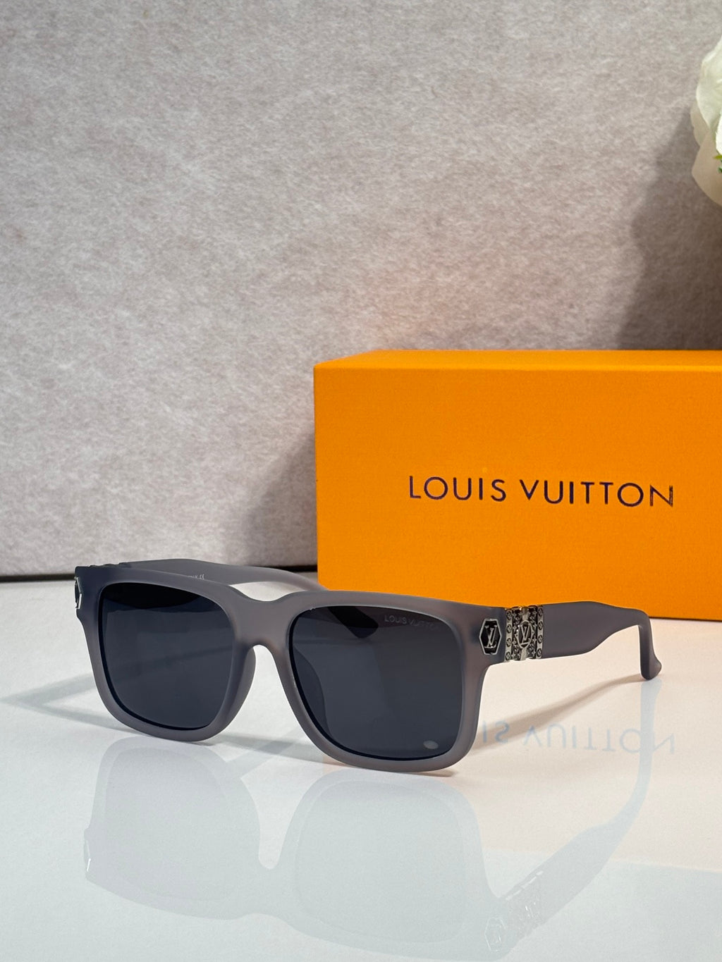 Louis Vuitton sunglasses with dark gray frames and black tinted lenses