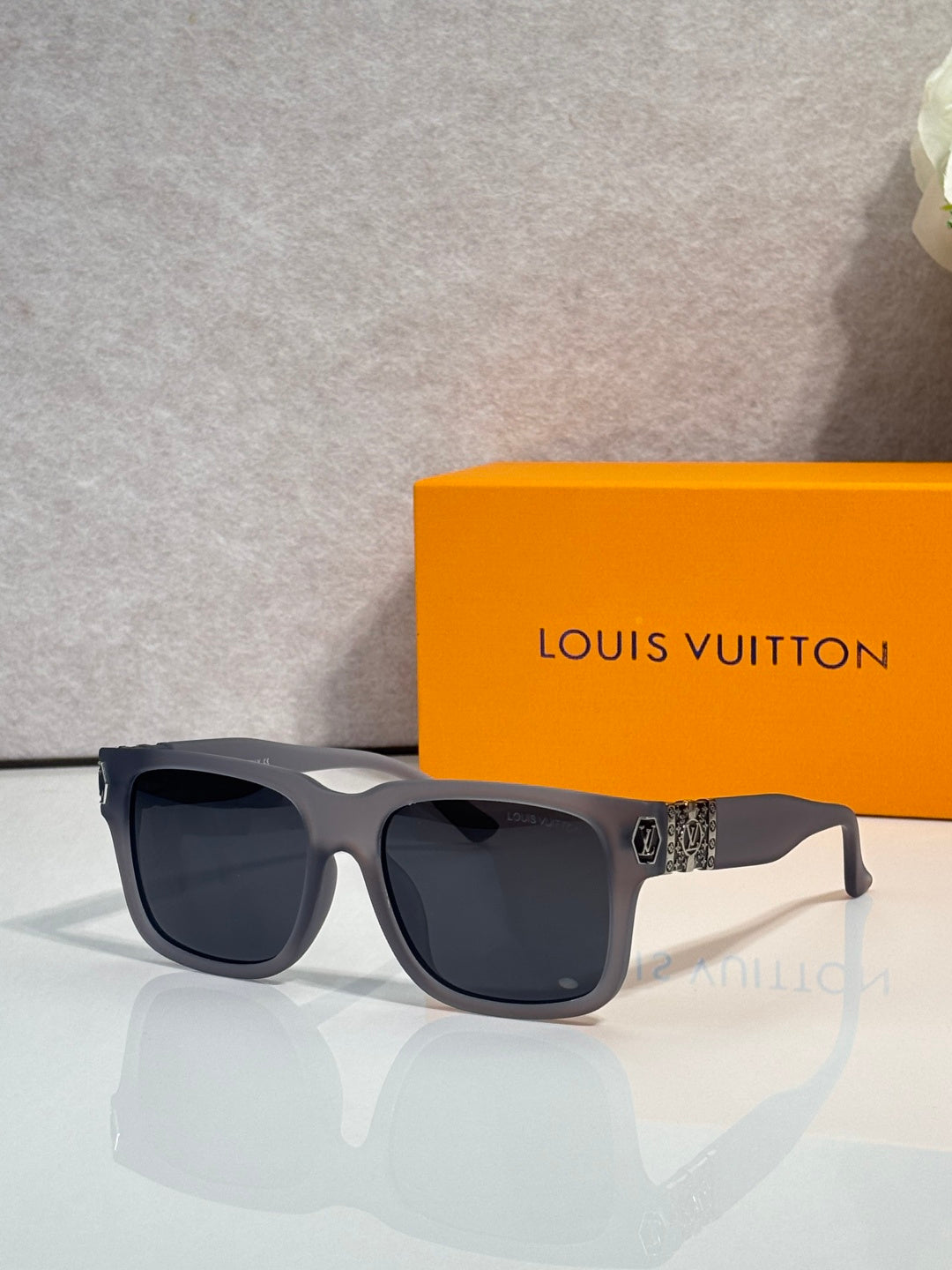 Louis Vuitton sunglasses with dark gray frames and black tinted lenses