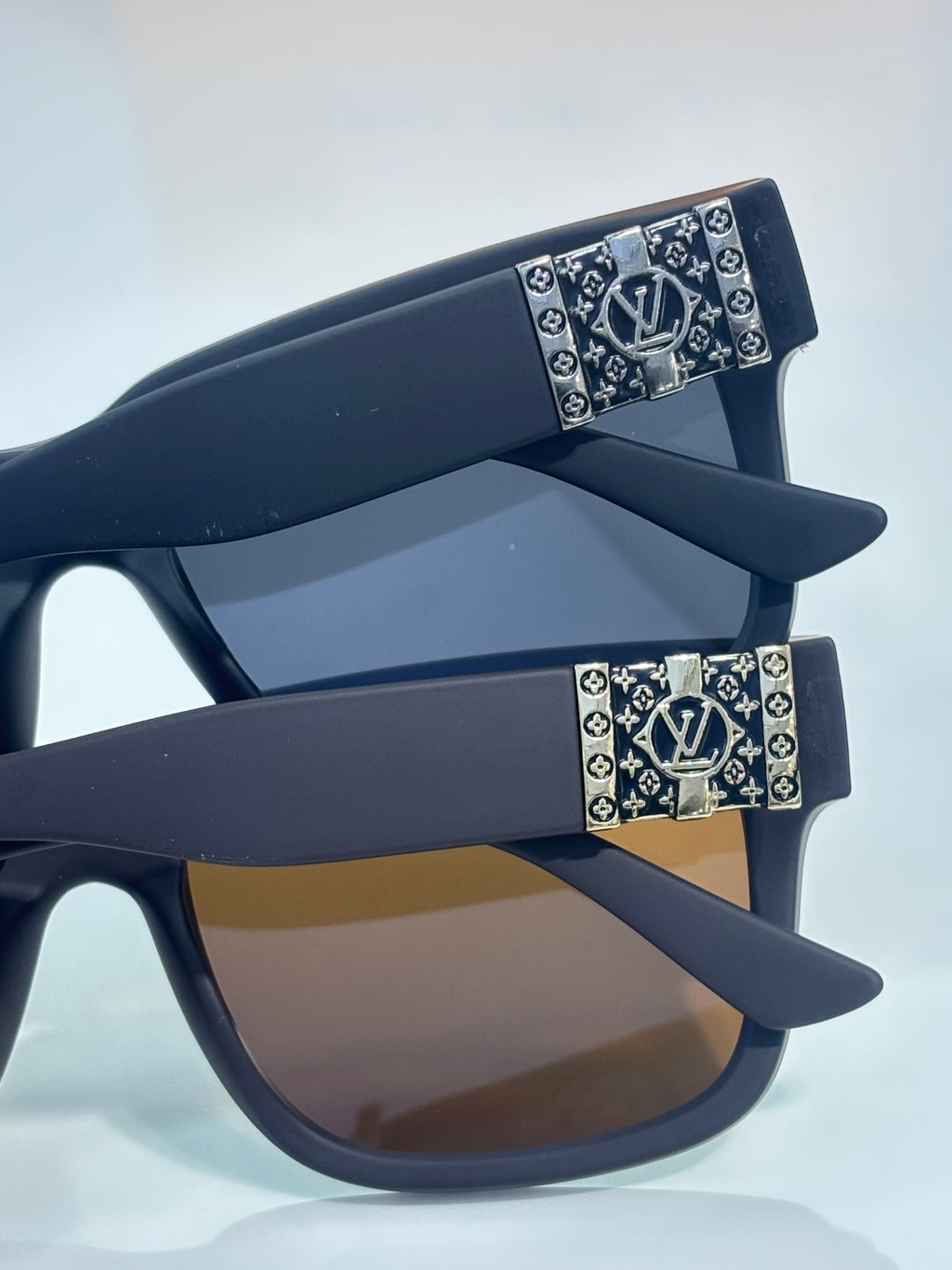 Louis Vuitton sunglasses with dark gray frames and monogram temple accents