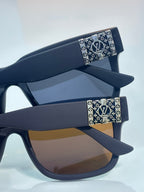 Louis Vuitton sunglasses with dark gray frames and monogram temple accents