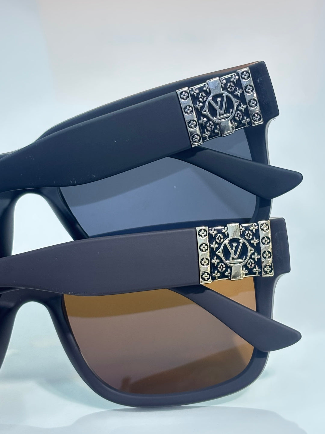 Louis Vuitton sunglasses with dark gray frames and monogram temple accents