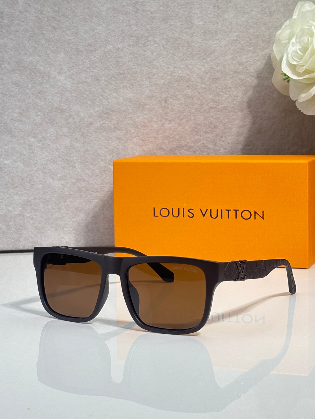 Louis Vuitton sunglasses with brown-tinted lenses and black/navy frames