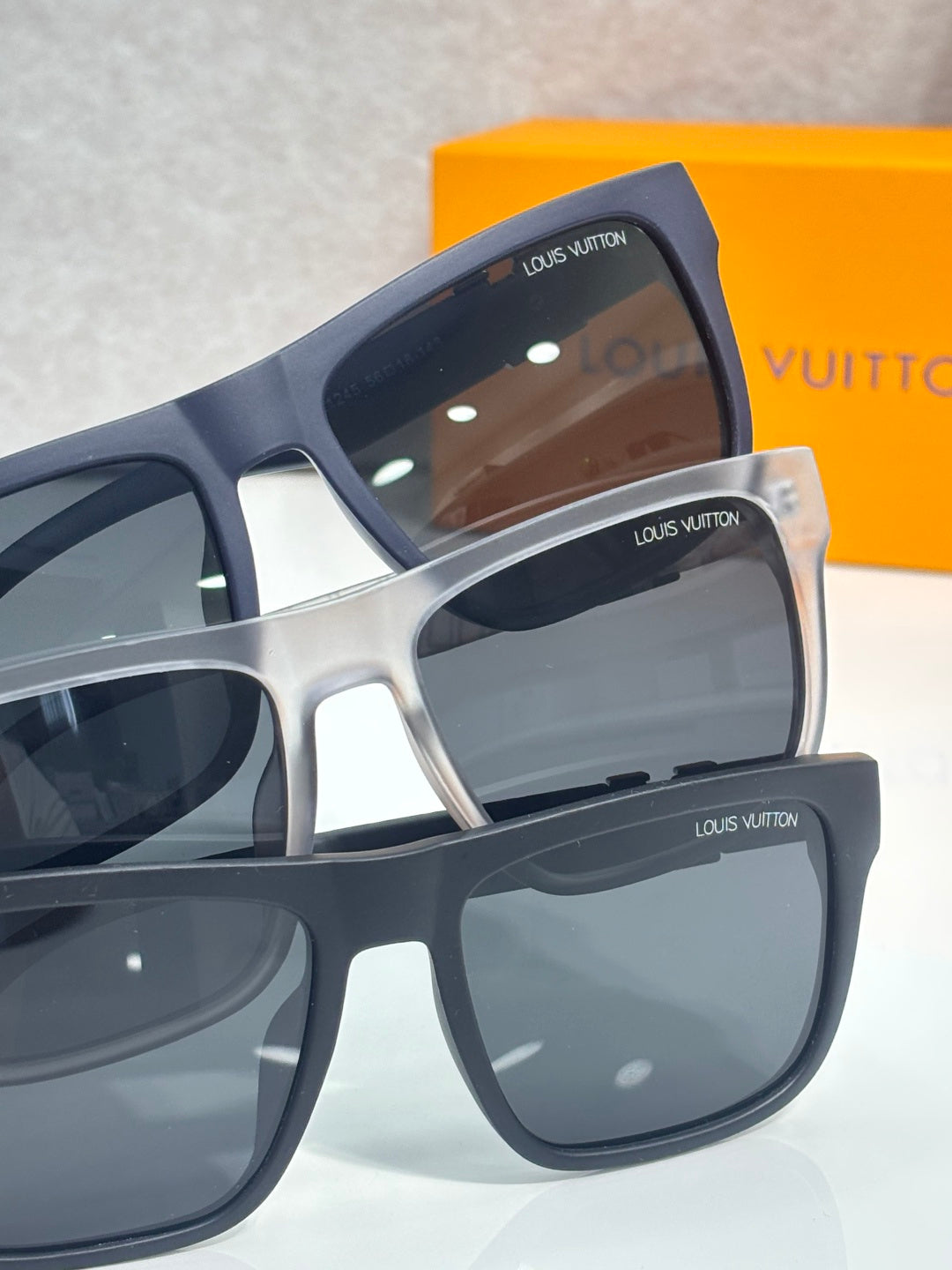 Louis Vuitton sunglasses side view with brown-tinted lenses and navy arms