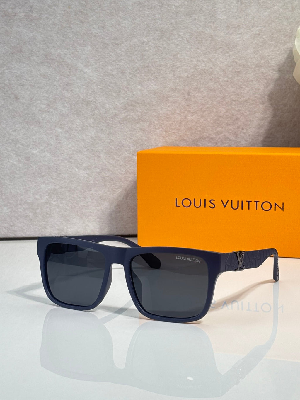 Louis Vuitton sunglasses with dark square lenses and navy frame, front view