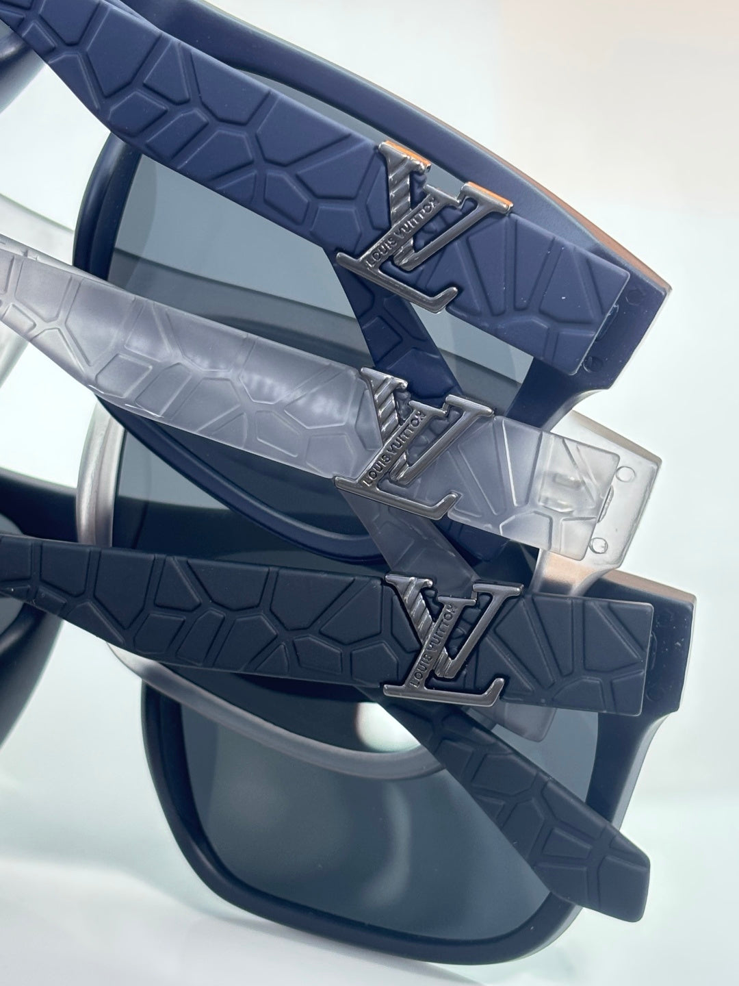 Louis Vuitton sunglasses temple detail with textured blue strap and metal logo
