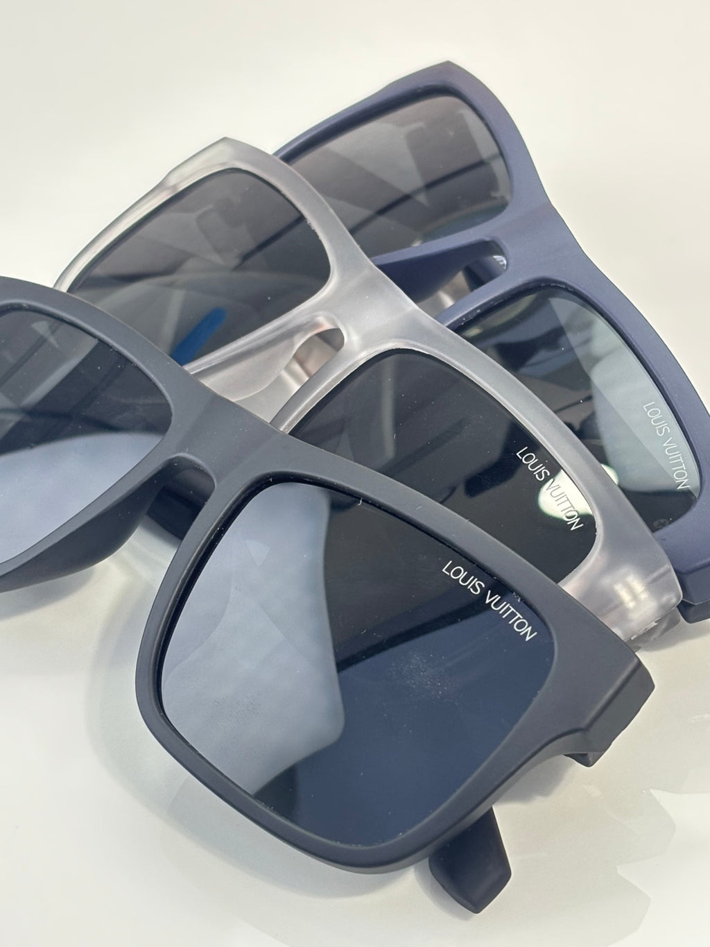 Louis Vuitton sunglasses pair with blue frames and dark lenses