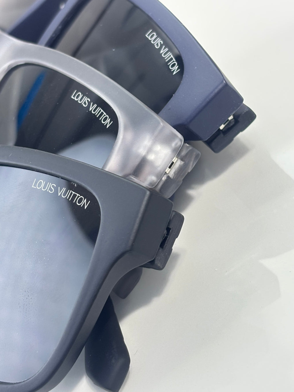 Louis Vuitton sunglasses arm detail with logo on dark blue temples