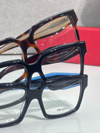 Prada rectangular eyeglasses close-up with dark blue and tortoise frames