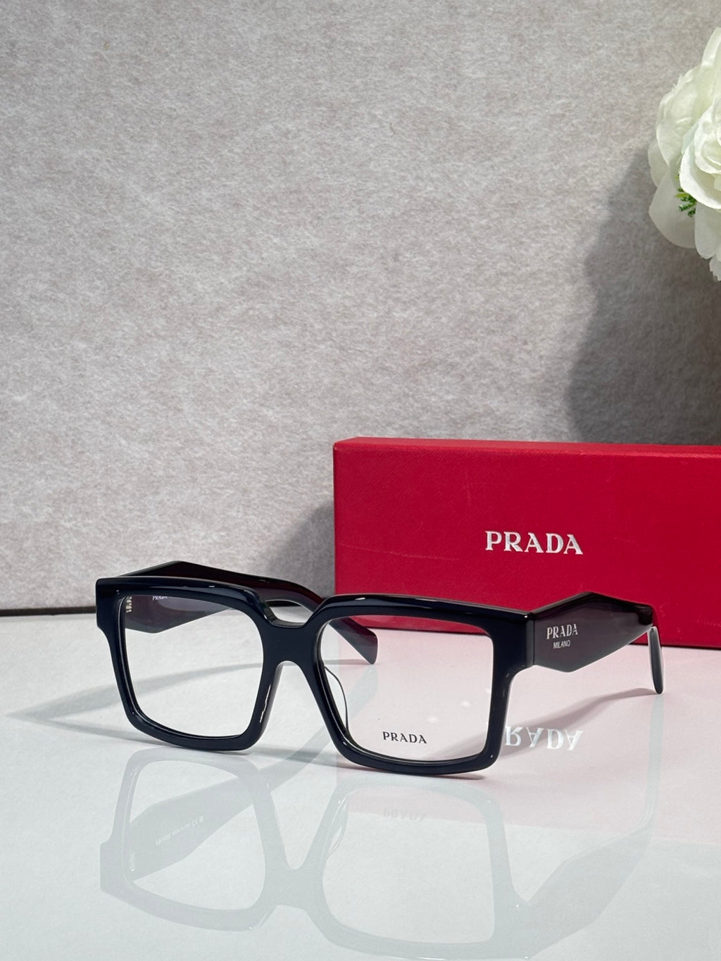 Prada rectangular eyeglasses with dark frames and clear lenses