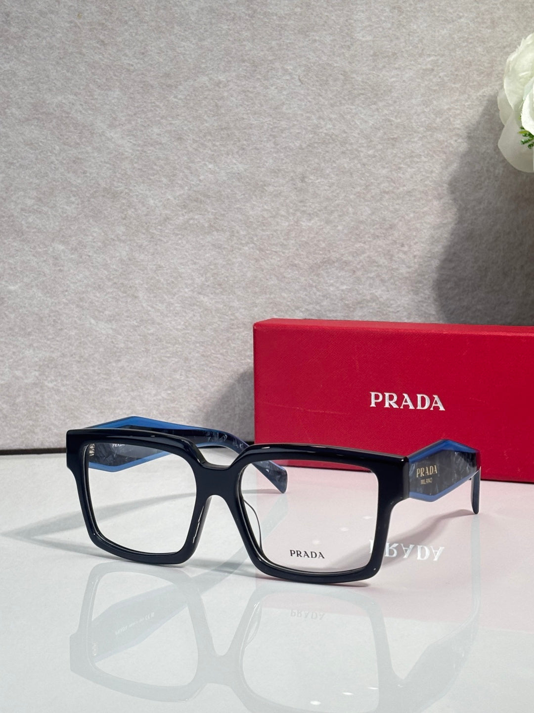 Prada rectangular eyeglasses with dark blue frames and clear lenses