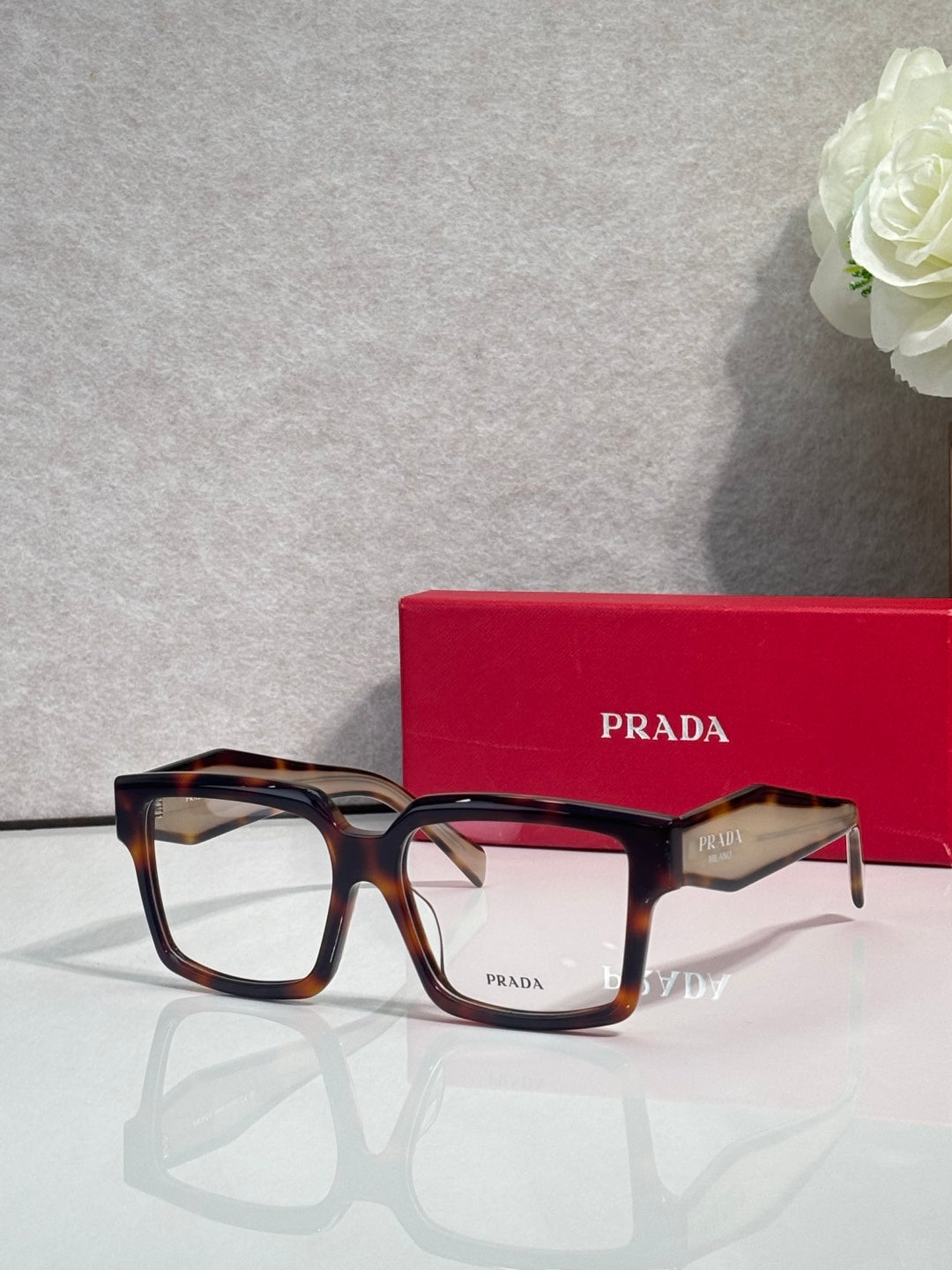 Prada rectangular eyeglasses with amber tortoise frames and clear lenses