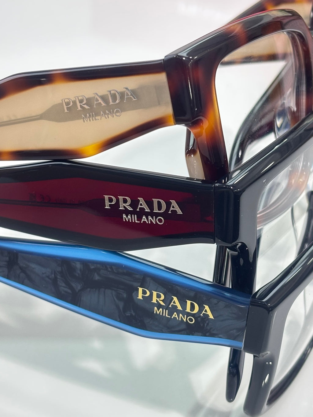 Prada eyeglasses close-up with tortoise and black temples and clear lenses