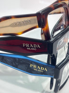 Prada eyeglasses close-up with tortoise and black temples and clear lenses