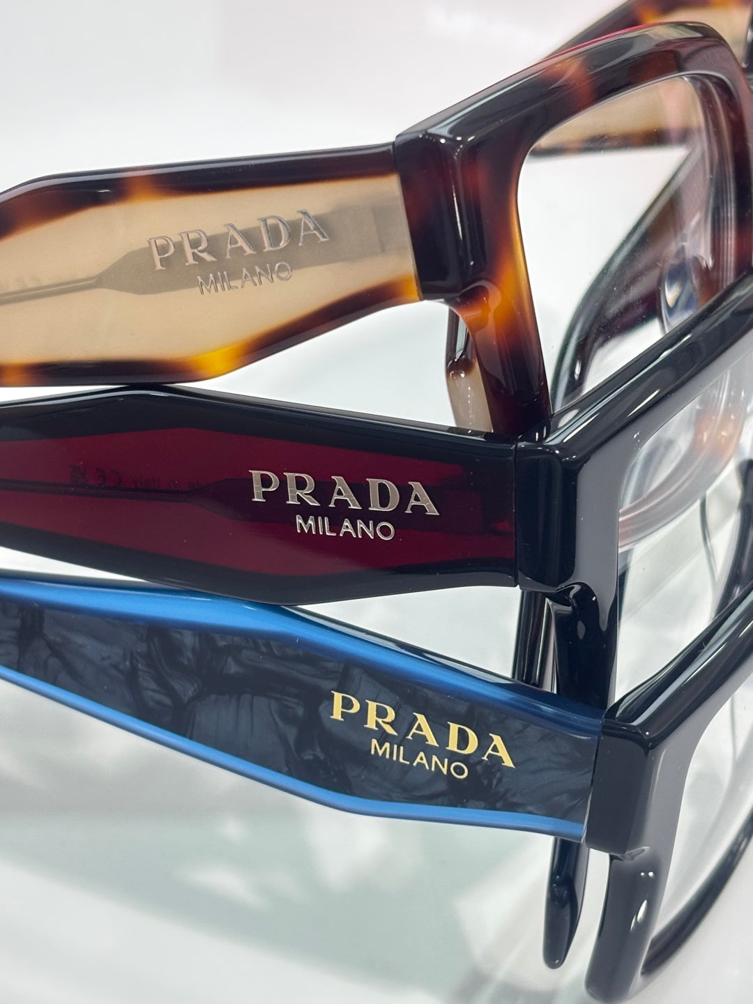 Prada eyeglasses close-up with tortoise and black temples and clear lenses