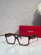 Prada rectangular eyeglasses with dark brown tortoise frames and clear lenses